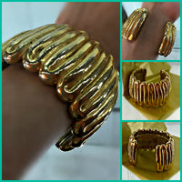Givenchy Cuff Bracelet Gold Plated Wave-Like Pattern Signed Plaque 72 Grams 1 7/8 Inches Wide 6 3/8 Inches Long